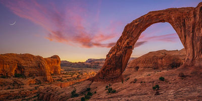 Corona Arch panorama at dusk with crescent moon