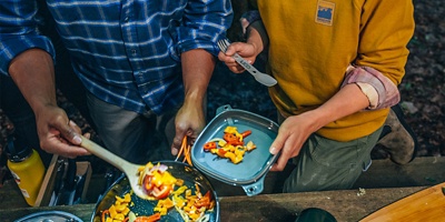 Two campers plating good in the woods