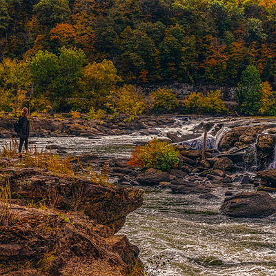 Female Hiker at Sandstone Falls With Fall Color, New River Gorge National Park, West Virginia.