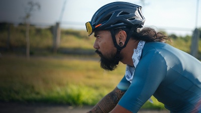A bearded cyclist in a jersey riding his gravel bike