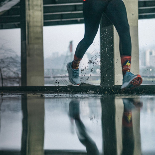 A close up of a runner through puddles
