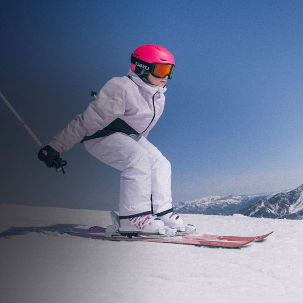 A skiier riding down a slope