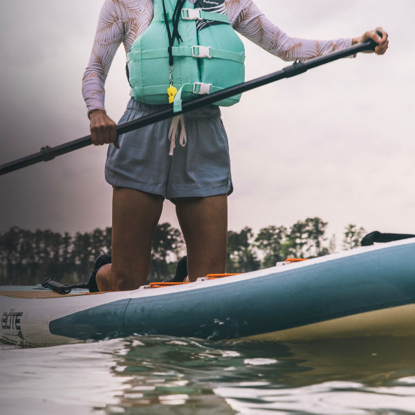 Detail of a SUP paddle boarder on a lake