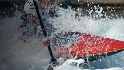 A kayaker races through the rappids.