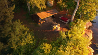 Aerial drone view of Lean to Campsite in the Adirondack mountains with a campfire burning.