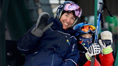 Two skiers sit on a lift at Mount Peter Ski Area