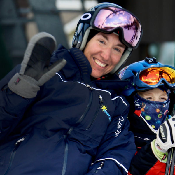 Two skiers sit on a lift at Mount Peter Ski Area