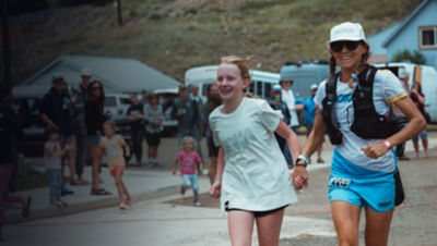  Darcy Piceu runs with a young girl