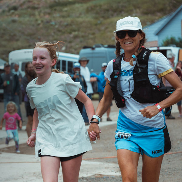  Darcy Piceu runs with a young girl