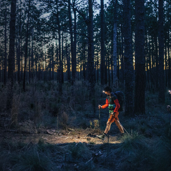 Two ultralight backpackers hike in the forest