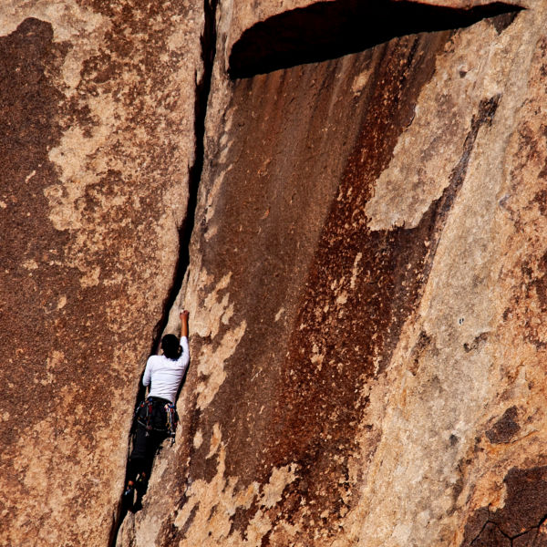A crack climber climbs the rock