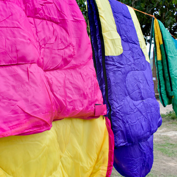 Drying sleeping bags. Many sleeping bags hanging on a rail after cleaning.