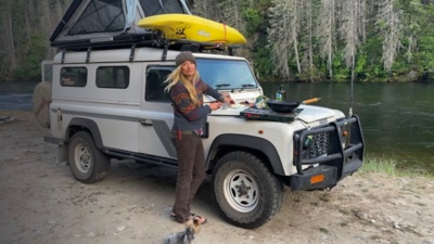 Mandela van Eeden poses by her car next to a river