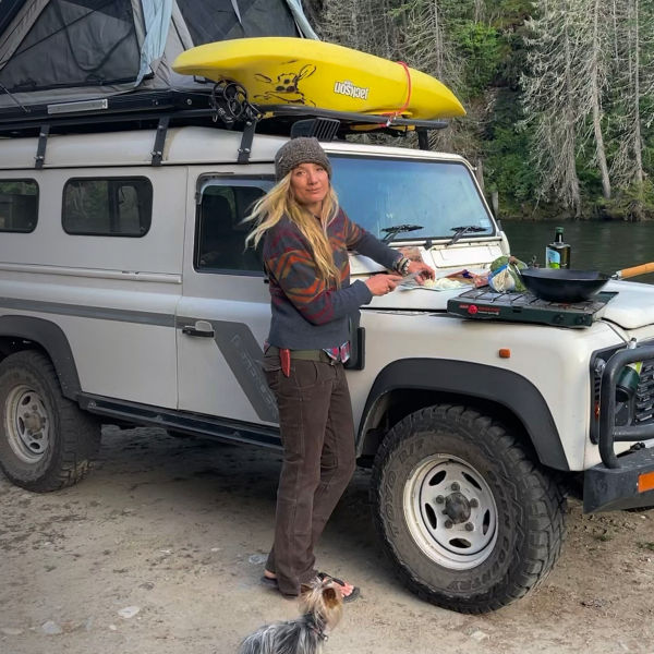 Mandela van Eeden poses by her car next to a river