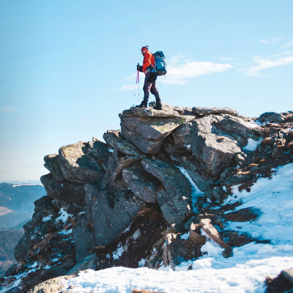 Mountaineer with a backpack on a mountain 