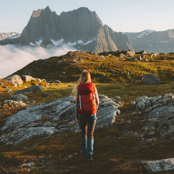 Woman hiking in mountains with backpack 
