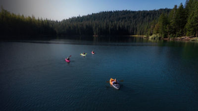 Group of friends kayaking Willow Lake in Southern Oregon on a summer morning