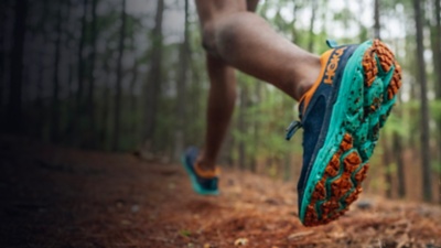 A detail of running shoes on a trail