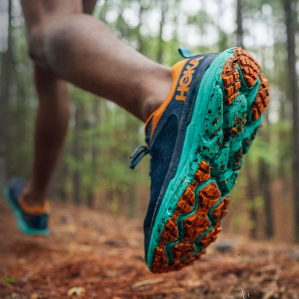 A detail of running shoes on a trail