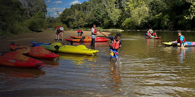 Kids kayak and play in the river with the Rivanna Conservation Alliance 