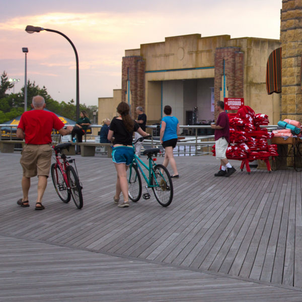 Bikers on the boardwalk and beach shop at historic Jones Beach State Park in Wantagh Ny