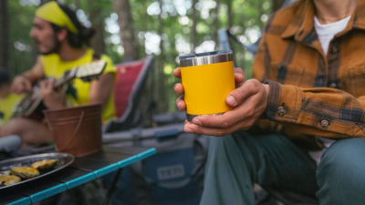 A man drinks out of a camping cup