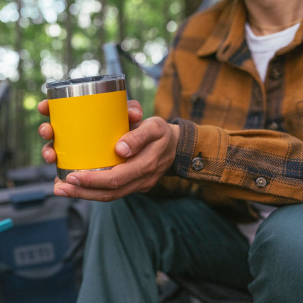 A man drinks out of a camping cup