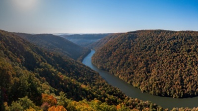 View up the Cheat River in narrow wooded gorge in the autumn.