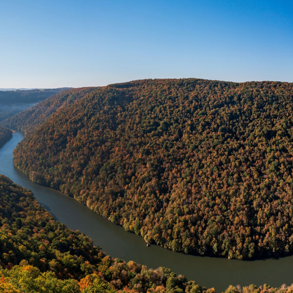 View up the Cheat River in narrow wooded gorge in the autumn.