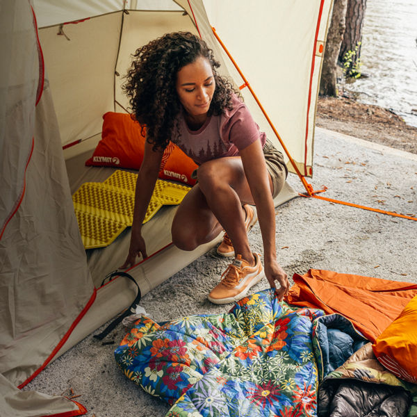 A group of friends set up camp on a beach