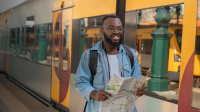 Tourist man with map at european terminal train station. 