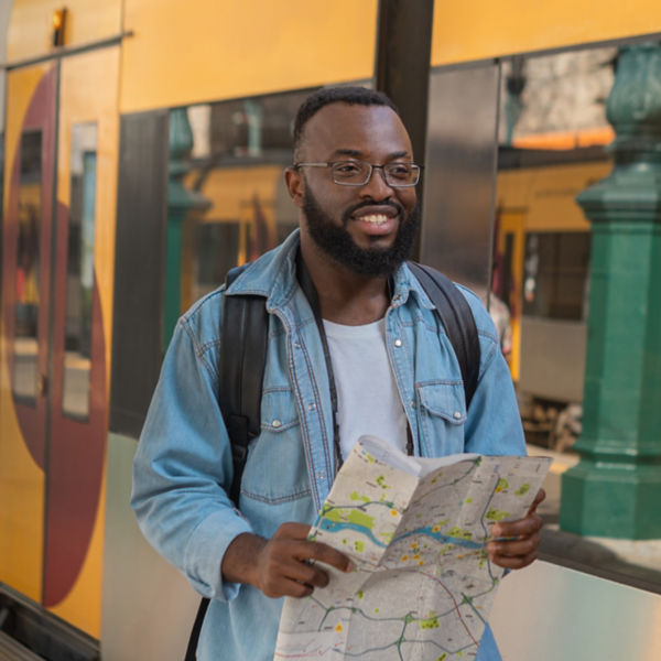Tourist man with map at european terminal train station. 