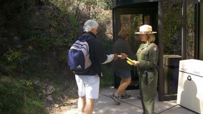 A ranger takes tickets at Wind Cave's walk-in entrance. Tours of Wind Cave are offered year-round.