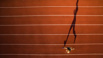 Shot of a young male athlete training on a track