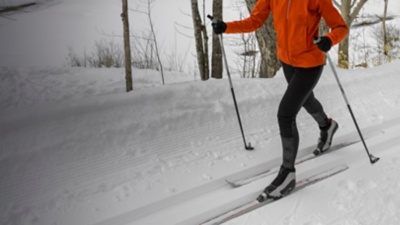 A person Cross Country skiing Classic Style Nordic Skiing in Forest.