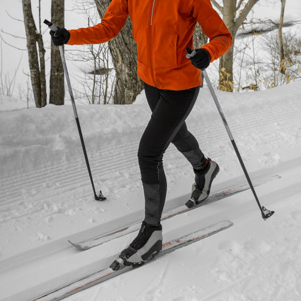 A person Cross Country skiing Classic Style Nordic Skiing in Forest.