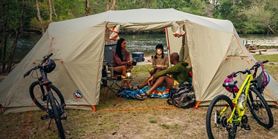 A family camping in a large tent