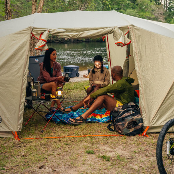 A family camping in a large tent