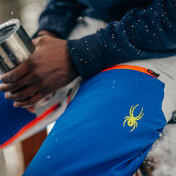 Detail of a mans snow pants with a spider