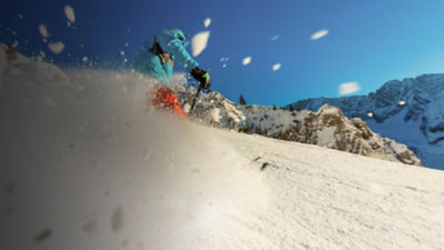 Young man freerider skiing downhill in the mountains. 