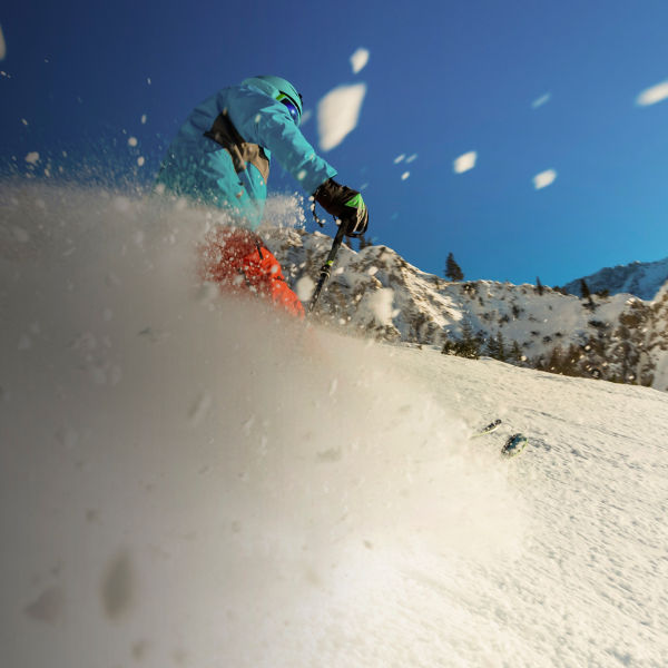 Young man freerider skiing downhill in the mountains. 