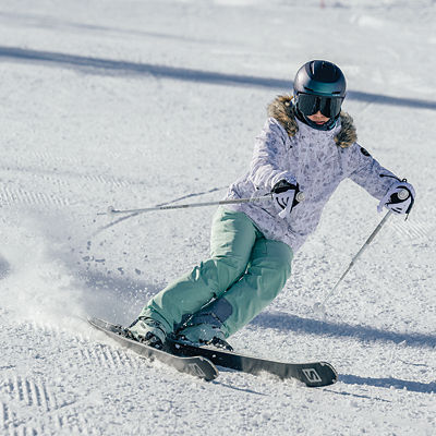 A woman skis down a mountain