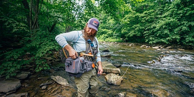 A fisherman looks into his bag for gear