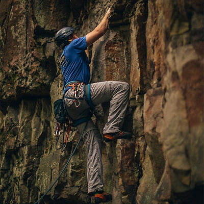 A man climbs up a rock in Ohiopyle