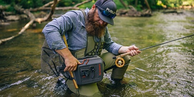 man using fishing gear in a stream