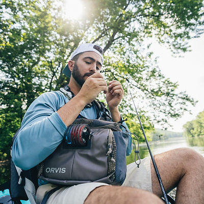 a man fixing his fishing hook