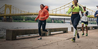 Group of runners downtown wearing jackets