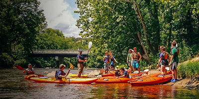 A group of kayakers enter the Cuyahoga River upstream of the Boston Mills Road bridge.