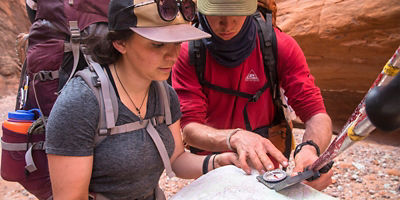 Backpacking through Escalante Grand Staircase National Monument with students learning outdoor skills.