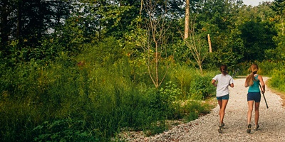 Two women trail run a trail in Frick Park